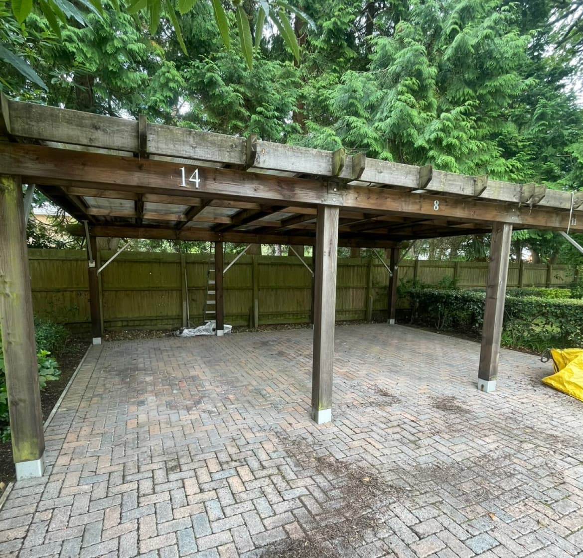 Car port before refurbishment, showing weathered timber