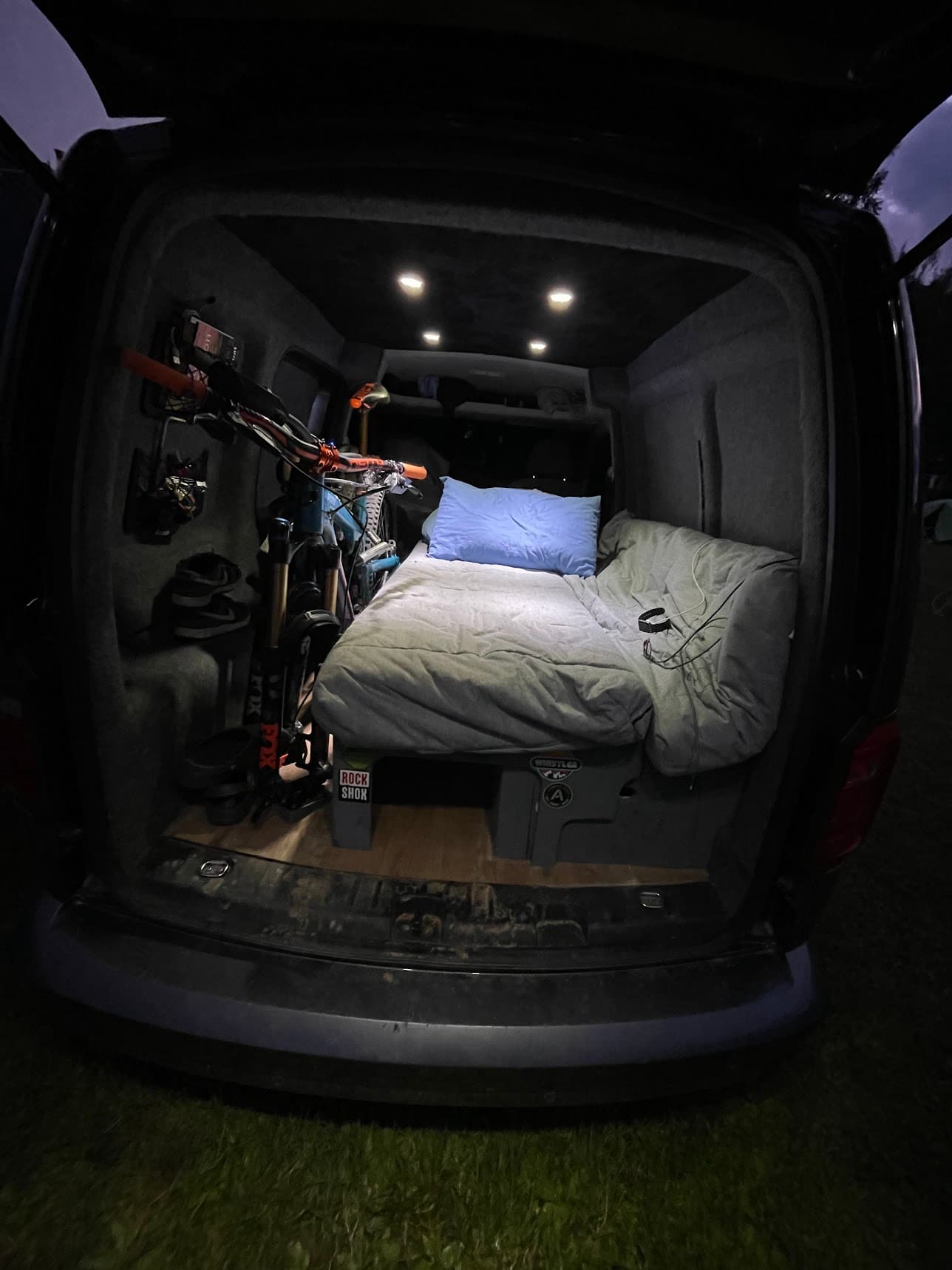 VW Caddy camper slide-out bed system in extended configuration