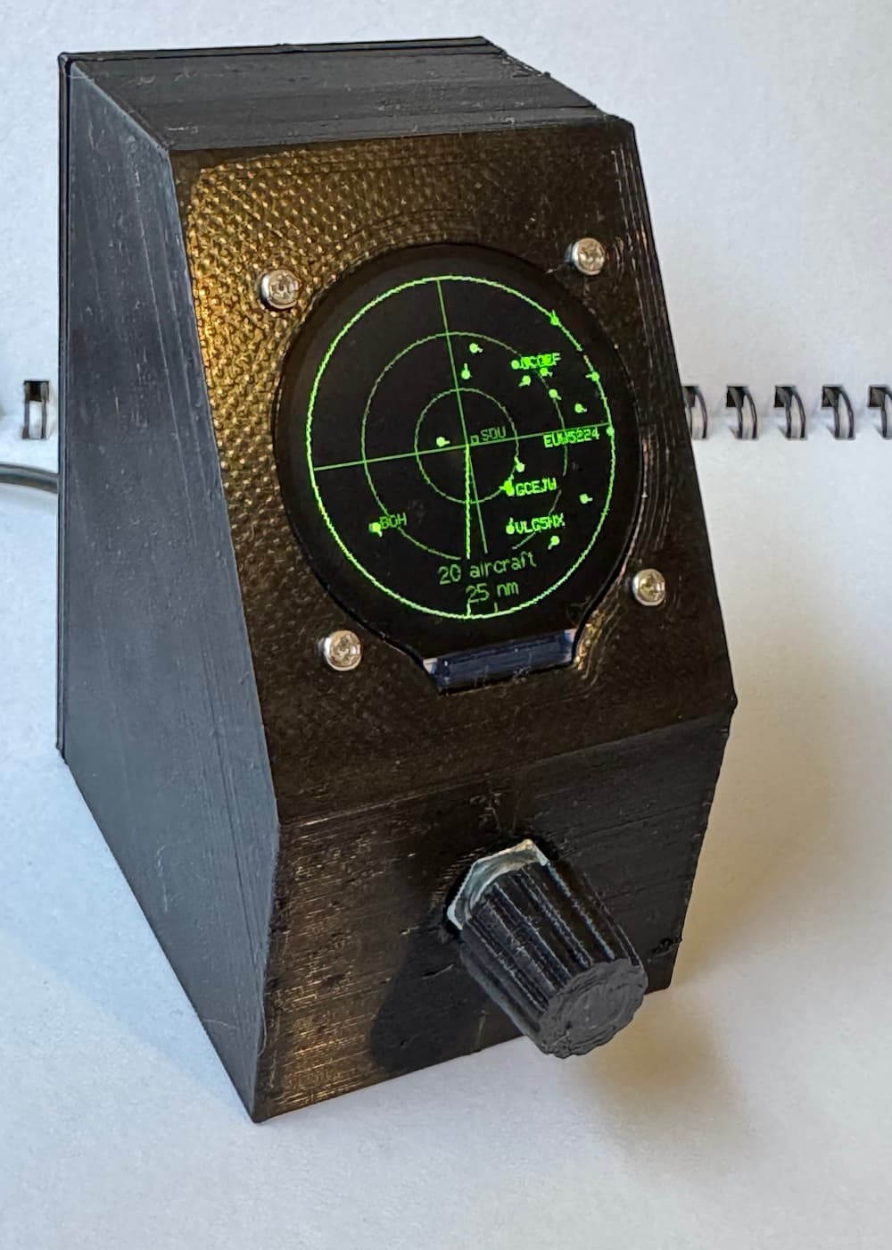 Completed black 3D-printed Flight Tracker displaying nearby aircraft on its circular green radar screen